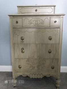 an antique chest of drawers with ornate carvings