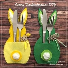 two bunny napkin holders with forks and spoons in them on a wooden table next to each other