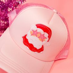 Star Eye Santa Trucker Hat! This pink hat features the cutest Santa glammed out with star eyes! This preppy Santa hat is perfect for the holiday season! The best gift for a bestie who loves trucker hats and Santa! This trucker hat is the best winter accessory! Complete your cozy look with this hat! Treat yourself or your bestie to this adorable hat! A unique accessory to make any outfit stand out! Spread the holiday cheer with this pink hat! This funky santa is just what you need for holidays! T Trendy Winter Trucker Hat, Trendy Winter Trucker Snapback Hat, Trendy Winter Trucker Hat Snapback, Pink Novelty Winter Hats, Pink Snapback Baseball Cap For Party, Pink Trucker Hat For Party With Curved Brim, Trendy Pink Party Baseball Cap, Pink Baseball Cap As Gift, Pink Trucker Hat As Gift