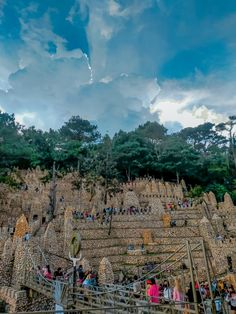 many people are walking up and down the stairs in front of an elaborate stone structure