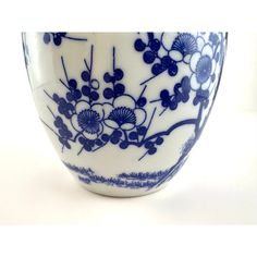 a blue and white bowl with flowers on the rim is shown in front of a white background