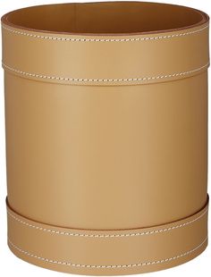 a tan leather container with stitching on the sides and white piping around the bottom