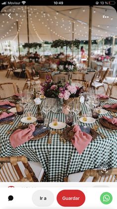 the table is set for an event with pink and green napkins on top of it