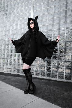 a size medium FOXBLOOD model earing an oversized bat wing hoodie with bat ears on the hood and wings attached to the arms. Her arms are opened wide to show off the wings Hooded Halloween Loungewear Hoodie, Halloween Hooded Loungewear Hoodie, Halloween Hoodie For Loungewear, Oversized Hoodie For Halloween, Oversized Hoodie Outerwear For Halloween, Gothic Hoodie For Halloween Cosplay, Alternative Style Halloween Cosplay Hoodie, Alternative Halloween Hoodie For Cosplay, Alternative Halloween Cosplay Hoodie