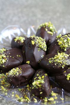 there are chocolates with pistachio and green sprinkles on them