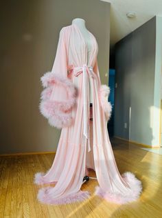 "Long pink sheer marabou feather robe with satin sash (photo shows built in style). Beautiful for boudoir, bridal and maternity shoots! Also just nice for a romantic night, getting ready or lounging at home! PLEASE MSG ME YOUR HEIGHT IF YOU REQUIRE TALLER THAN 5'8\" WITH HEELS/SHOES Comes in all colors and sizes (message for info). All of these are handmade to order. For custom color requests please allow time for me to get materials and make it." Husband Killer Robe, Pink Robe With Fur, Pink Fluffy Robe Aesthetic, Pink Night Robe, Fur Aesthetic, Fancy Robes, Feather Shoes, Pink Nightgown, Maternity Shoots