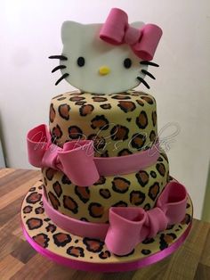 a hello kitty cake with leopard print and pink bows