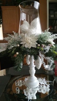 a glass table topped with a vase filled with flowers