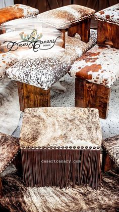 several wooden benches covered in cowhide and fringes