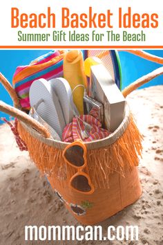 a basket filled with beach items sitting on top of a sandy beach