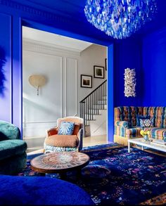 a living room filled with furniture and a chandelier