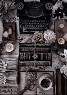 an old fashioned typewriter surrounded by books and flowers