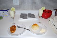 there are two plates with food and drinks on the counter next to eachother