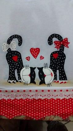 an image of two cats on a table with hearts and polka dots in the background