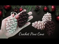 crochet pine cone ornament in the palm of someone's hand