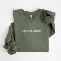 Embrace your role as "one hell of a mother" with this trendy and oversized sweatshirt, perfect for all the cool moms out there. This mom life graphic tee is not only a great gift for new moms or a fun option for Mother's Day, but it's also a stylish and comfy addition to your wardrobe.      SIZING    * UNISEX sizing  * Please check the size chart in the listing photos for measurements. Size down for a tighter fit Normal size for loose comfy fit Size up for oversized.     HOW TO ORDER    2. Selec Mother's Day Funny Print Crew Neck Shirt, Cute Crew Neck T-shirt For Mother's Day, Mother's Day Long Sleeve Sweatshirt With Embroidered Text, Funny Customizable T-shirt For Mother's Day, Mother's Day T-shirt With Funny Text And Crew Neck, Funny Mothers Day Gifts, Introvert Humor, Mom Sweater, Beste Mama