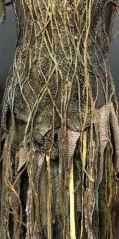 a dress made out of branches and vines