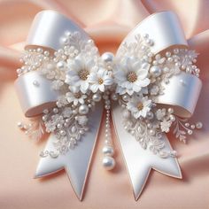 a white bow with pearls and flowers on it