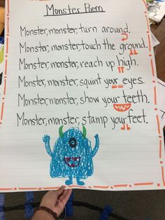 a child's hand holding up a sign with writing on it that says monster plan