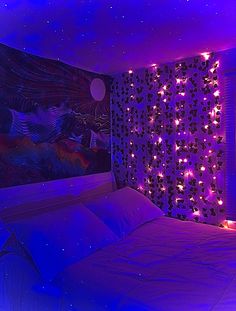 a bed in a room with purple lights on the headboard and wall behind it