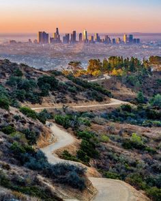 the city skyline is seen in the distance as it sits on top of a hill