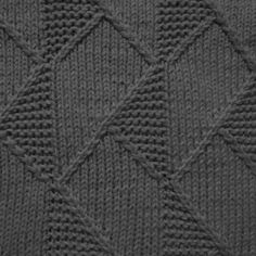 a close up view of a knitted sweater with diamond shapes on the front and sides