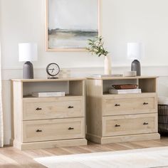 two wooden dressers sitting next to each other in a room with a painting on the wall