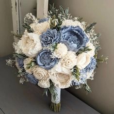 a bridal bouquet with blue and white flowers