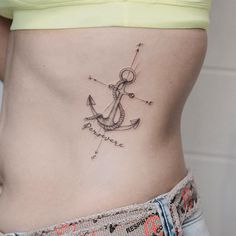 an anchor tattoo on the side of a woman's stomach