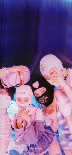 three girls wearing hats and holding their hands together