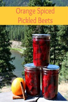 orange spiced pickled beets in jars on a picnic table with an orange next to them