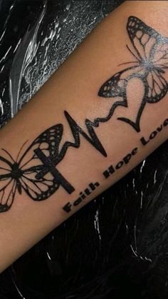 a woman's arm with butterflies and the words faith hope love written on it