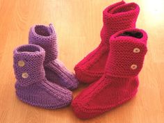 three knitted boots sitting on top of a wooden floor