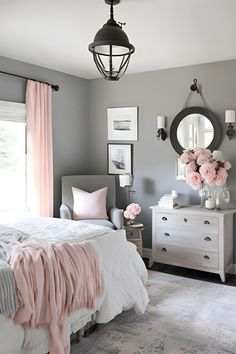 a bedroom with gray walls and pink accents