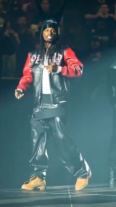 a man in black and red jacket standing on stage