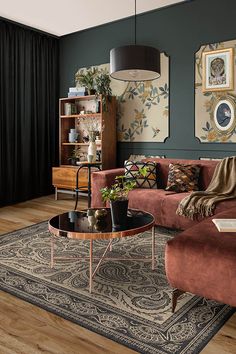 a living room filled with furniture and decor on top of a hard wood floored floor