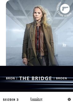 a woman in a trench coat standing next to an advertisement for the movie iron the bridge