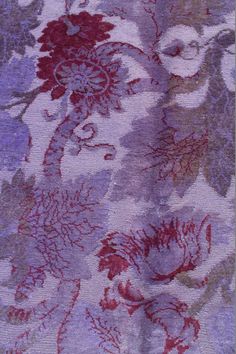 a purple and red floral pattern on fabric