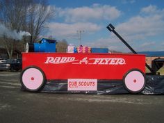 an old radio flyer car is parked in the parking lot