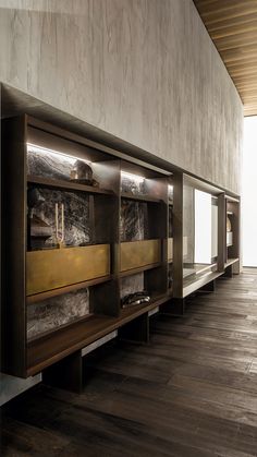 an empty room with wooden flooring and metal cabinets on the wall, in front of a large window