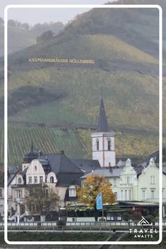 a town with mountains in the background and a white square frame over it that says,