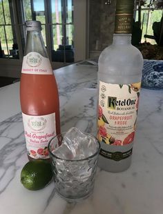 two bottles of alcohol sitting on top of a counter