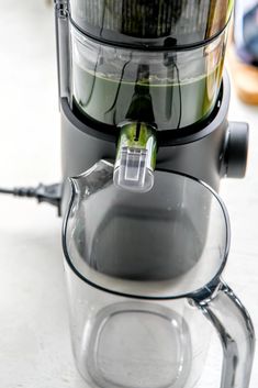 a close up of a juicer on a table