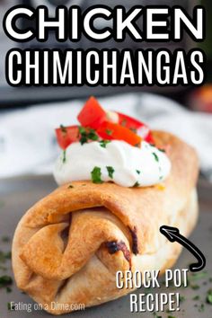 chicken chimichangas with sour cream and tomatoes on top, sitting on a plate