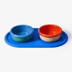 two bowls are sitting on a blue tray