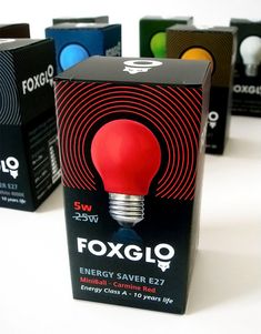 several boxes with different types of light bulbs in them on a white surface, including one for foxgl and the other for energy saver