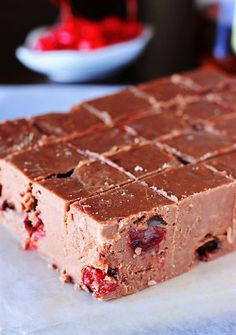 a close up of a piece of chocolate with cherries