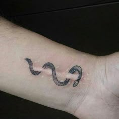 a person with a tattoo on their arm that has a snake in the middle of it