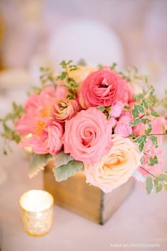 pink and yellow flowers in a vase on a table