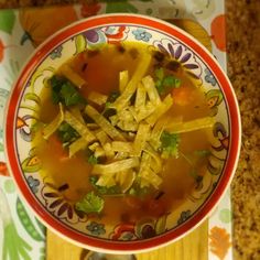 a bowl filled with soup sitting on top of a table